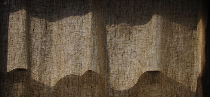 A Robert Spellman photograph of afternoon sunlight coming through curtains.