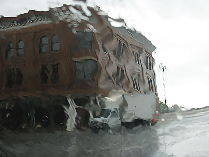 photo of building through a rainy windshield.