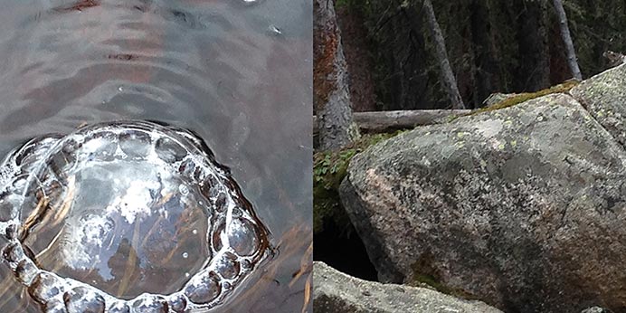 Photograph of a bubble in a stream and a boulder nearby.